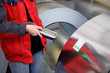 Photo: A worker has scanned steel roll production A worker has scanned steel roll production