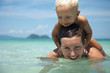 Happy Mom and son bathing in the sea