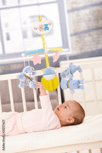 Photo: Baby playing with bed mobile Baby playing with bed mobile
