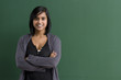 Women crossed arms at the blackboard.
