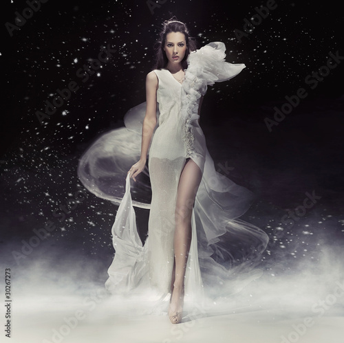Photo: Beautiful brunette lady in white dress Beautiful brunette lady in white dress