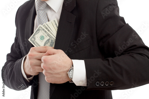 Photo: Man in a putting money in his pocket. Man in a putting money in his pocket.