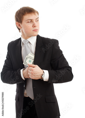 Photo: Man in a putting money in his pocket. Man in a putting money in his pocket.