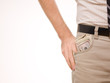 A man putting american money in his pants pocket A man putting american money in his pants pocket