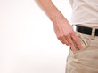 A man putting american money in his pants pocket A man putting american money in his pants pocket