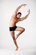 young male dancer posing over grey background young male dancer posing over grey background