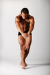young male dancer posing over grey background young male dancer posing over grey background