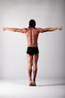 young male dancer posing over grey background young male dancer posing over grey background