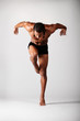 young male dancer posing over grey background young male dancer posing over grey background