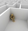 Depression - depressive mannequin sitting in corner of big maze