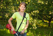 Girl works with  grass-cutter