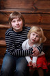 Brother and sister sitting at the stairs.