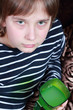 Young boy with green mug.