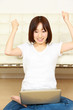 young woman pleased by something on her computer screen