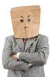 Businessman in ecological paper bag on head and crossed arms.