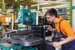 trainee working at a rotary cutter
