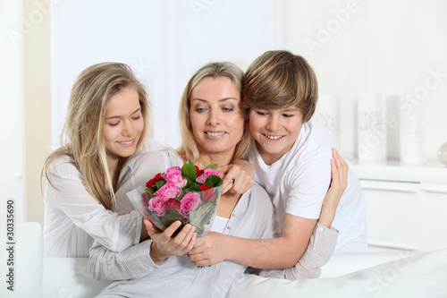 Photo: Children offering bunch of flowers on mother's day Children offering bunch of flowers on mother's day
