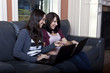 Two Young woman using laptops