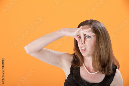Photo: Woman Pinches Her Nose Woman Pinches Her Nose