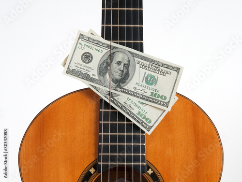 Photo: Classical guitar and money Classical guitar and money