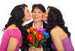 Daughters kissing mother