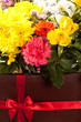 Flowers and red ribbon bound box