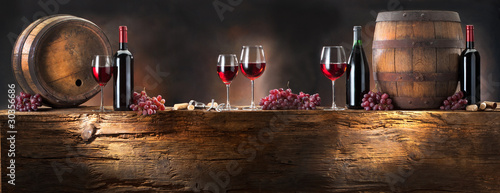  still life with red wine with barrel on old wood