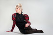 attractive young woman posing sitting on studio