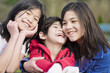 Two sisters and their disabled little brother at the park,
