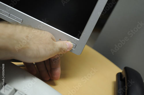 Photo: Hand pressing power button Hand pressing power button