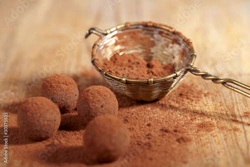 Photo: chocolate truffles cocoa powder dusted and sieve, shallow dof chocolate truffles cocoa powder dusted and sieve, shallow dof