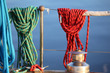 Colorful ropes hanging on yacht railings, closeup.