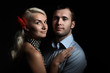 Foto: Young couple in love together on dramatic black background Young couple in love together on dramatic black background