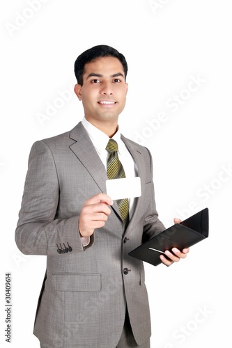 Photo: Indian business man holding a name card. Indian business man holding a name card.