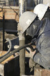 Construction workers pumping cement