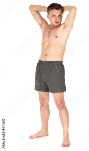 Photo: standing naked young man with raised arms standing naked young man with raised arms
