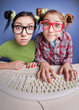 Twin sisters at the computer