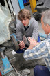 Teenager in professional training in workshop Teenager in professional training in workshop