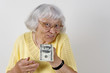 Senior woman offering cash Senior woman offering cash