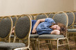 Woman sleeping at a boring conference