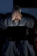 Man in housecoat working late series shocked computer crash