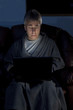 Man in housecoat working late series worried