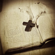 cross on the Bible .