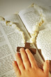 child hand and cross on the Bible .