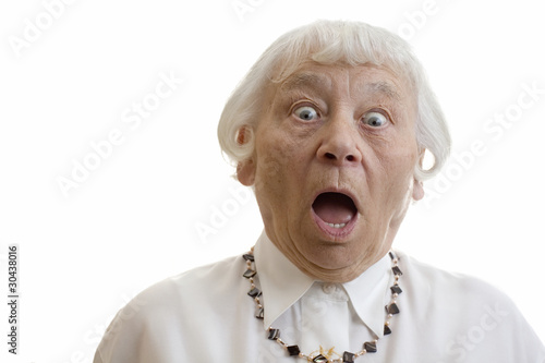 Photo: Senior woman studio portrait gasping shocked Senior woman studio portrait gasping shocked