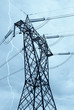 high-voltage pylon under cloudy sky