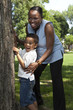 Mother and son playing hide and seek at a park Mother and son playing hide and seek at a park