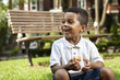 Young boy eating at a park Young boy eating at a park