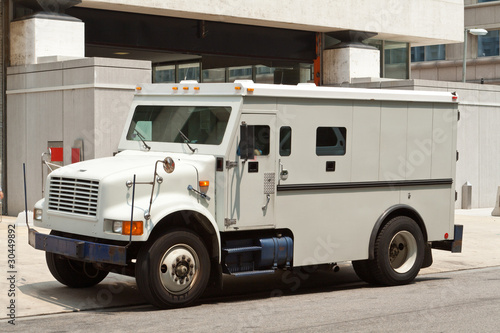 Photo: Armoured Armored Car Parked on Street Building Armoured Armored Car Parked on Street Building