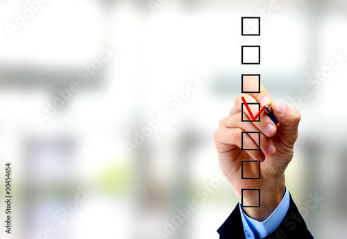 Photo: Hand choosing one of three options Hand choosing one of three options
